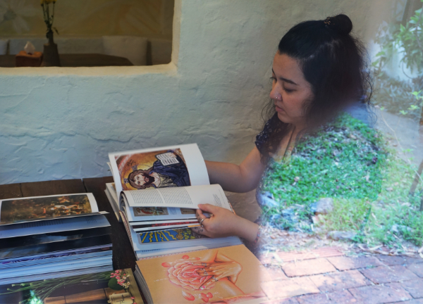 A woman sitting with a stack of art and reference books, deeply absorbed in reading — a translucent double-exposure effect blends her with a garden behind her